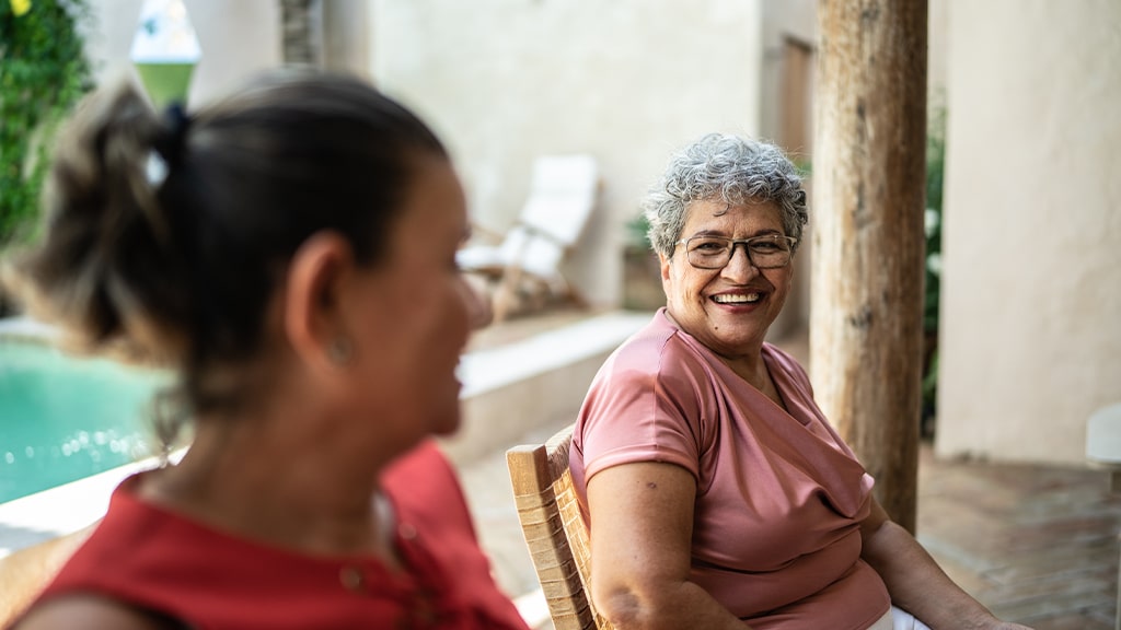 Two women sitting outside enjoying each others company