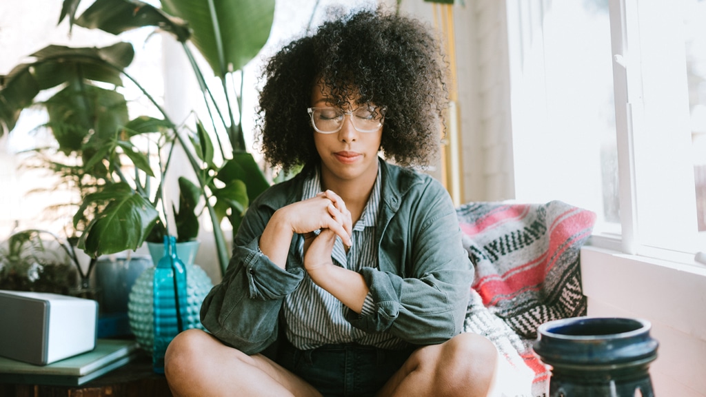Women sitting with hands near heart and eyes closed in a mindfulness activity